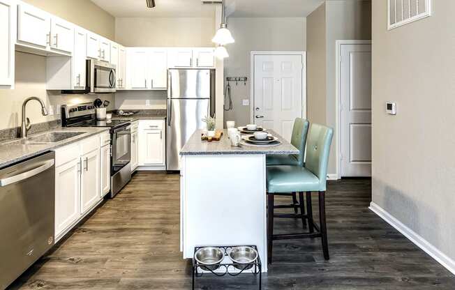Kitchen with white cabinets and stainless steel appliances at Legacy Commons Apartments in Omaha, NE