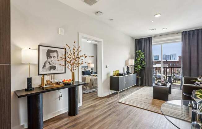 A modern living room with a black and white framed picture on the wall.