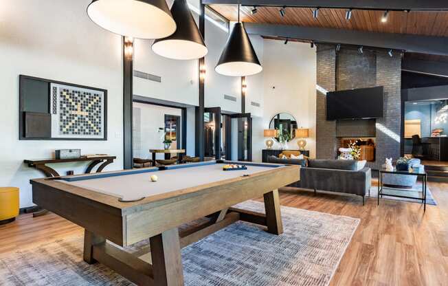 a pool table in a living room with a tv