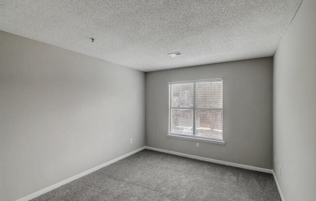 an empty living room with a window at The Sapphire, Decatur, 30035