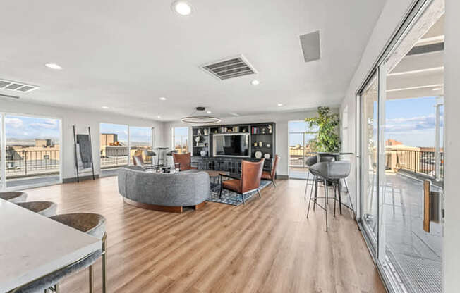 A modern living room with a curved sofa and a television.