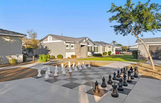 A giant chess board in the middle of a driveway.