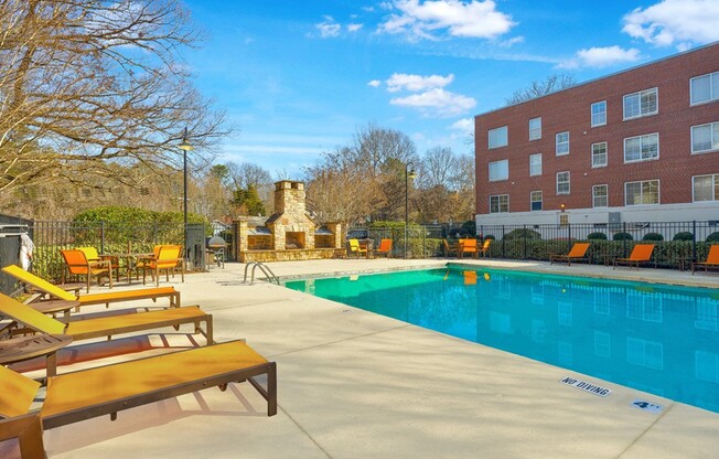 Dive into relaxation at Icon Downtown Durham, featuring a stunning pool surrounded by comfortable loungers and a cozy fire pit. The perfect blend of leisure and style awaits. Explore your new home today!