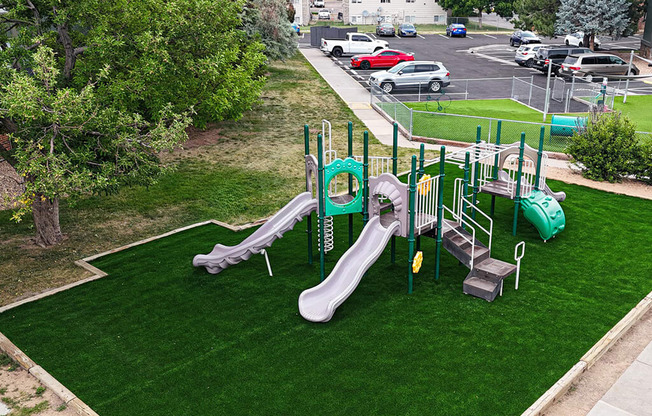 A playground with a green slide and a yellow circle.
