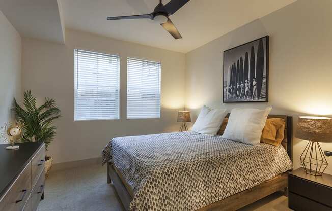 a bedroom with a bed and a ceiling fan