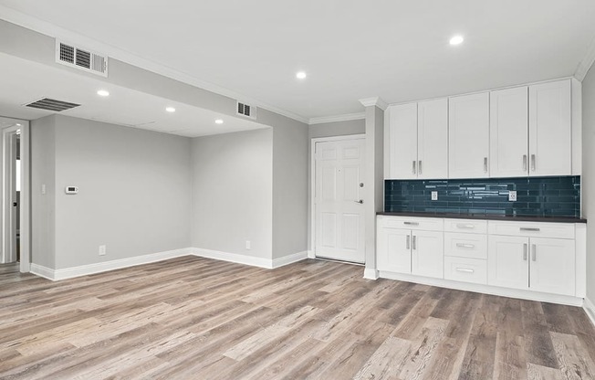 Hardwood floored living room with additional storage and countertop.