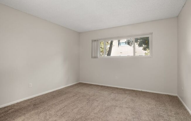 an empty living room with a window