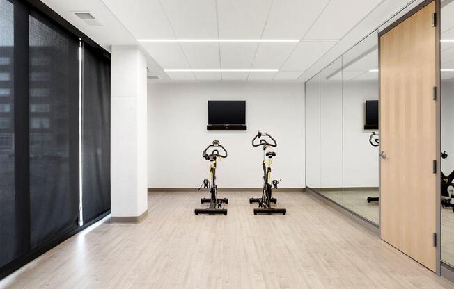 yoga studio with wood floors and spin bikes