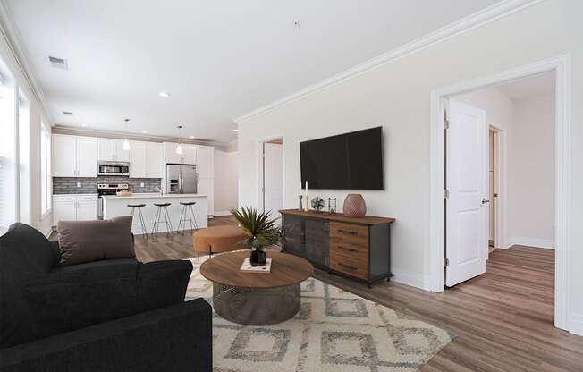 A living room with a black couch and a coffee table.