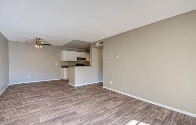 A room with wooden flooring and a ceiling fan.