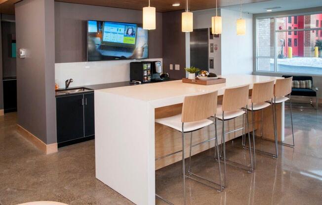 Zest Community kitchen with island, seating and tv