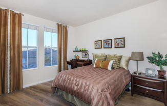 a bedroom with a bed and a chair in a room
