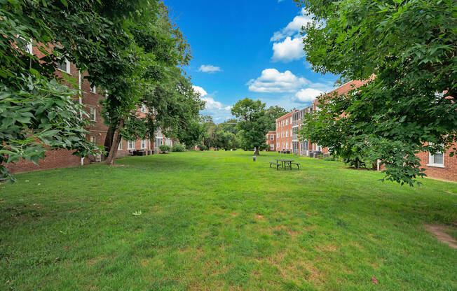 A park with a grassy area and trees.