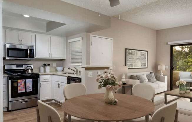 A modern kitchen with a dining table set for four.