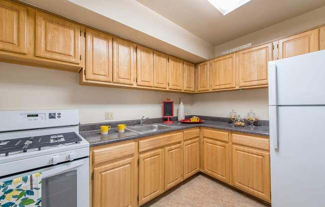 A kitchen with wooden cabinets and a white refrigerator.