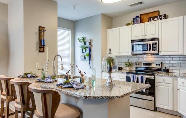 a kitchen with a counter top and a stove top oven at Sterling Manor, Williamsburg