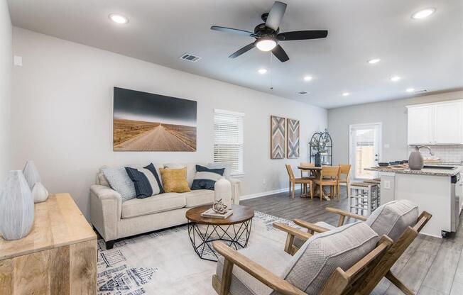 a living room filled with furniture and a ceiling fan