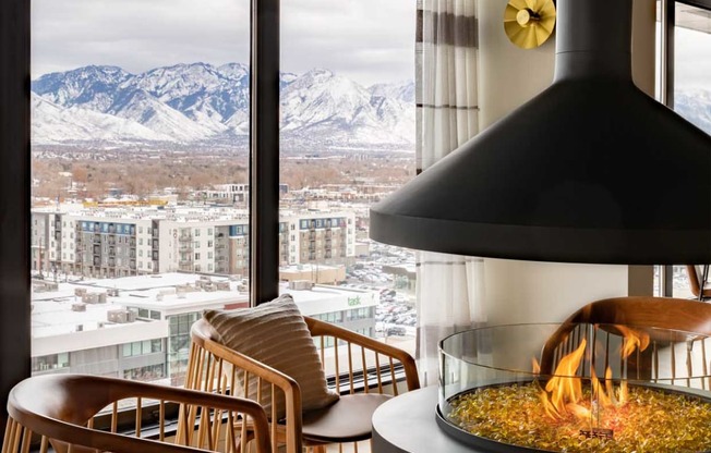 a fireplace in a hotel room with a view of the mountains