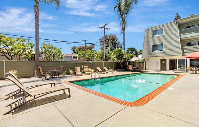 A pool with a red border and a slide in the middle.