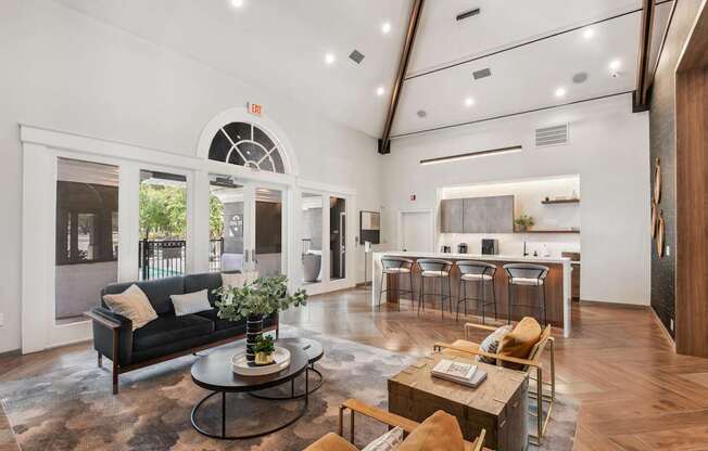 A living room with a black couch and a coffee table.