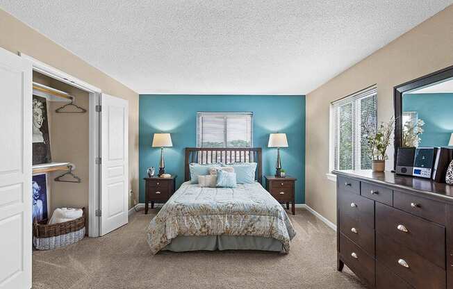 a bedroom with a bed and a dresser