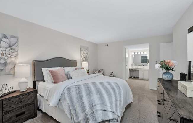 a bedroom with a bed and dresser