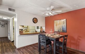 a dining room with a table and chairs and a ceiling fan