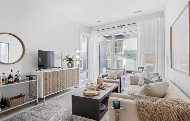 A modern living room with a large window and a flat screen TV.