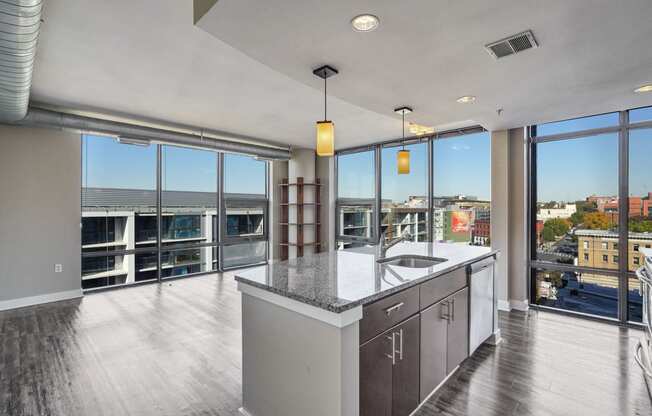 a kitchen with a large island and a view of a city