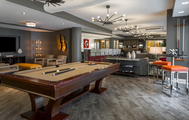 a clubhouse with a pool table and a bar