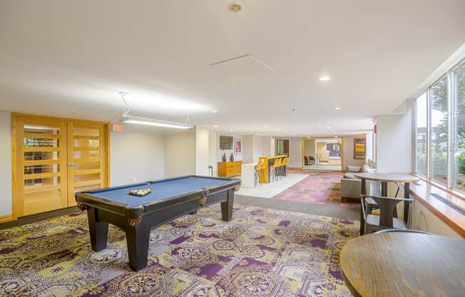 A pool table in a room with a purple carpet.