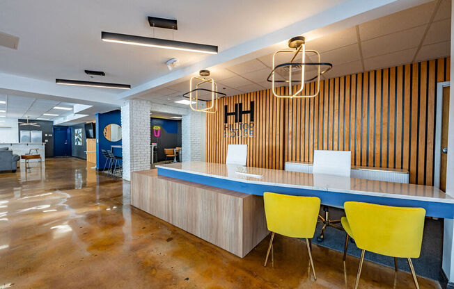 a conference room with a blue counter and yellow chairs