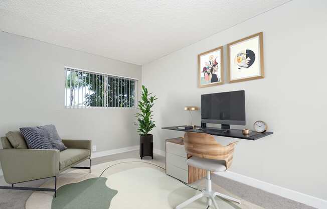 A living room with a couch, chair, and television.