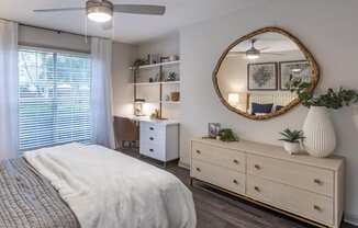 a bedroom with a bed and a mirror at Roswell Village, Roswell, Georgia
