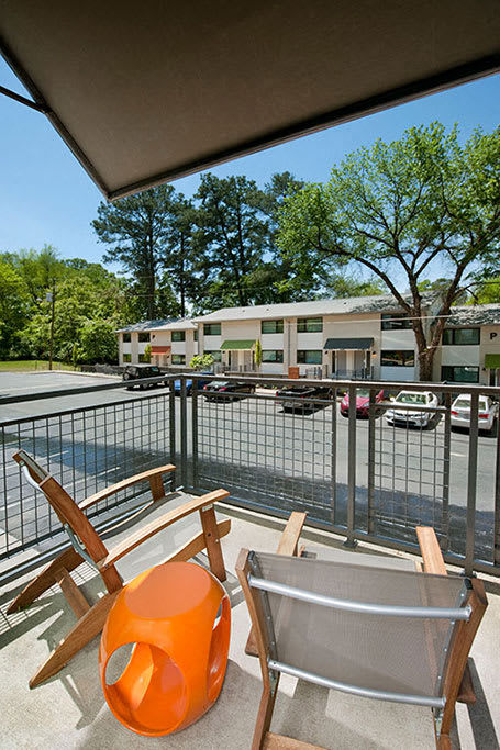 A patio with a chair and table.