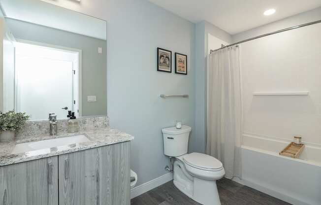 a bathroom with a toilet sink and a shower