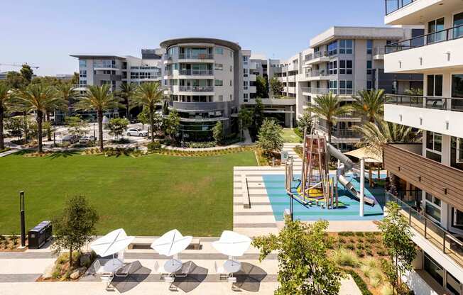 A modern apartment complex with a pool and outdoor seating area. at Elements Apartments*, California