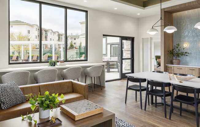 a living room and dining room with a table and chairs