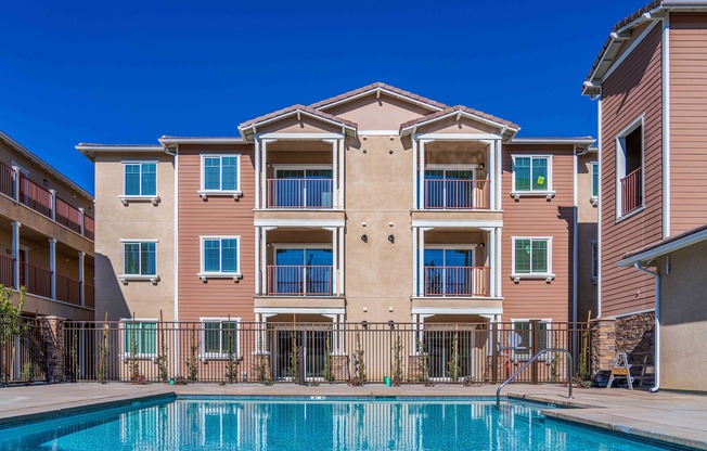three story apartment building with pool in front at Turtle Creek apartments