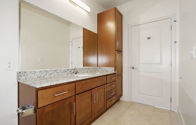 Full bathroom with granite at Avenue Grand Apartments in White Marsh, MD