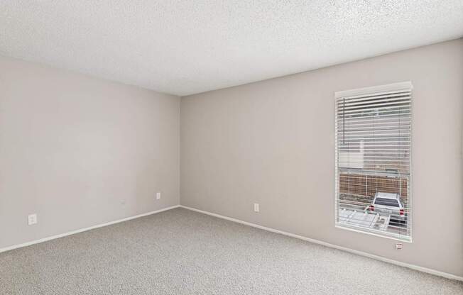 Carpeted B6 bedroom with a window at Windridge on the Parkway in Dallas, TX