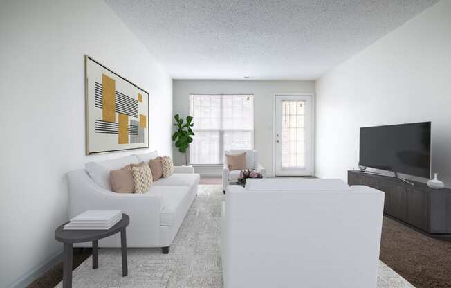 a living room with a white couch and a tv