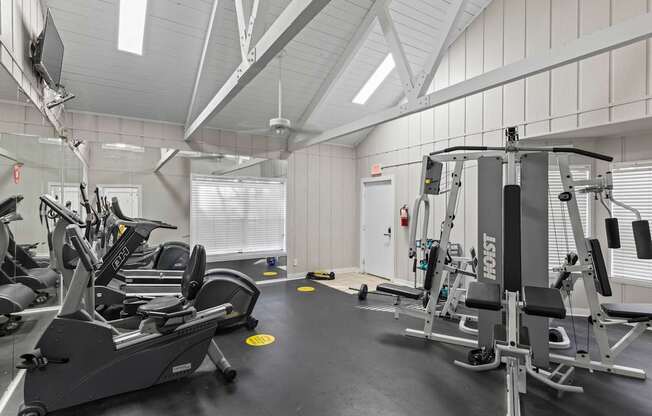 A gym with treadmills, elliptical machines, and weight machines.