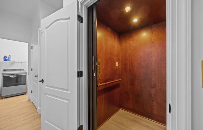 A laundry room with a washing machine and dressing room