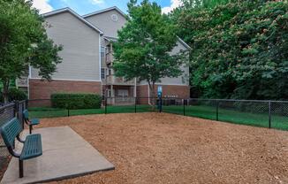 Gated dog park with benches at Ashley Oaks Apartments in Greensboro, North Carolina