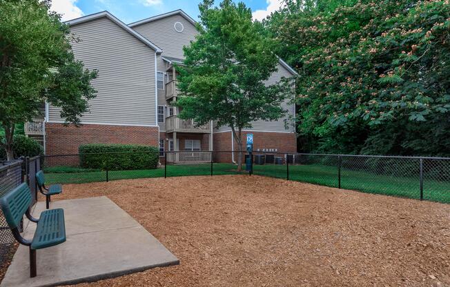 Gated dog park with benches at Ashley Oaks Apartments in Greensboro, North Carolina