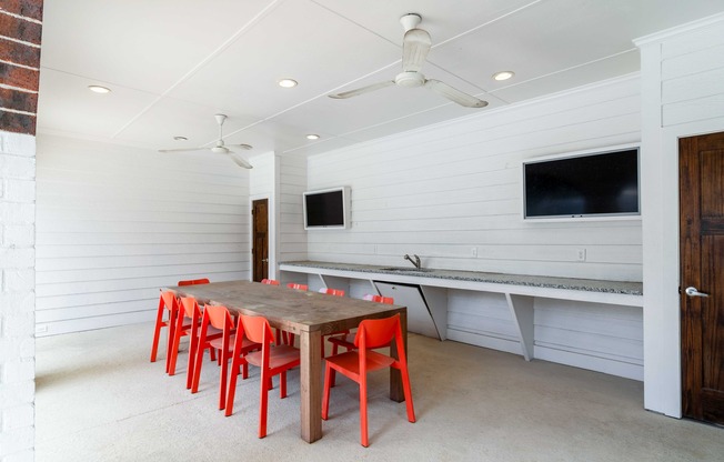 Outdoor porch area with large table and chairs