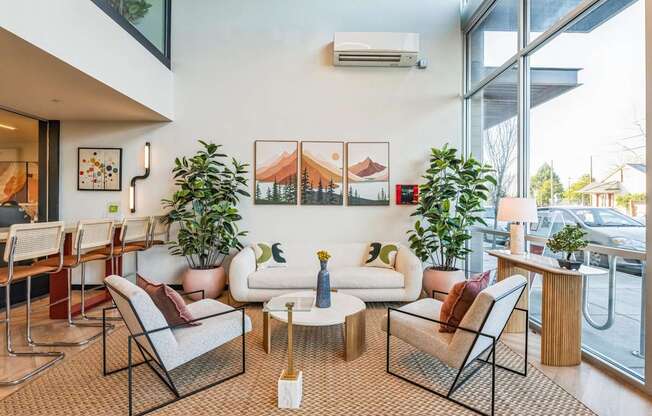 A living room with a couch, chairs, and a coffee table.