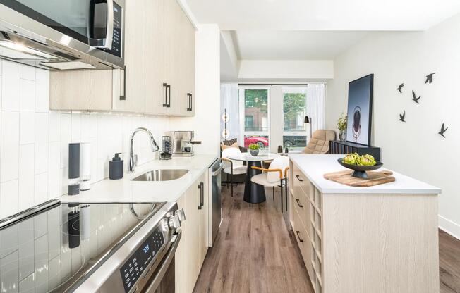 Bright, modern, and functional—this streamlined kitchen features quartz counters, designer cabinetry, and an open flow into your living space.