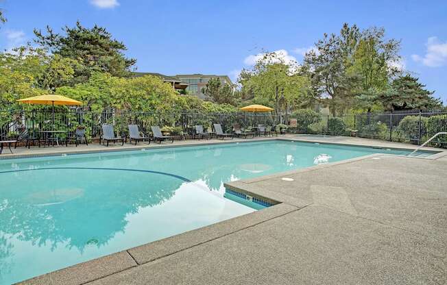 Lakeside outdoor pool and lounge chairs, Dean Weidner Real Estate Apartments in Mountlake Terrace, WA